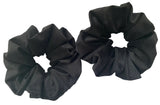 Two black scrunchies on a white background
