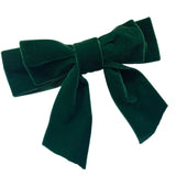 A large bottle green velvet hair bow with a silver-colored clip attached for fitting, displayed on a white background.
