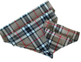A beige, black, and red tartan slip on collar design dog bandana laid out on a white background.