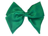An emerald green satin hair bow clip displayed on a white background, with a silver-colored barrette clip attached.