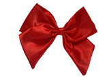 A red satin hair bow clip displayed on a white background, with a silver-colored barrette clip attached.