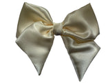 A cream/beige  satin hair bow clip displayed on a white background, with a silver-colored barrette clip attached.