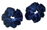 Two navy blue scrunchies on a white background