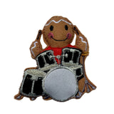 Decorative gingerbread man playing drums on a white background