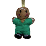 Felt gingerbread man ornament with green  scrubs on a white background
