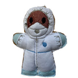 CSI gingerbread man decoration. In white suit with blue gloves and sho covers.