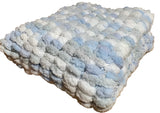 Blue, grey and white, hand knitted pom pom wool pram cover.