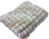 Pom pom blanket knitted.