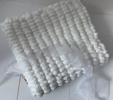 Pom pom blanket knitted.