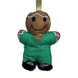 Gingerbread man ornament with green scrubs on a white background
