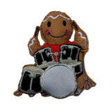 Felt ornament of a gingerbread man playing drums on a white background