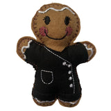 Beautician felt gingerbread decoration. Dressed in black cotton tunic and trousers with white buttons and decorative finish. Lightly filled with a polyester filling to create depth and character. Hand sewn to finish.