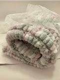 Pom Pom blanket knitted.