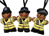 British Transport Police Officer felt gingerbread decorations, showing cap, helmet or female officer decorations on white background.