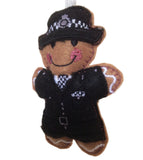 Felt ornament of a police officer wearing a uniform and hat on a white background
