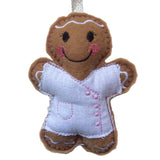 Beautician felt gingerbread decoration. Dressed in white cotton tunic with baby pink buttons and decorative finish. Lightly filled with a polyester filling to create depth and character. Hand sewn to finish.