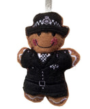 Gingerbread man ornament dressed as a police officer (female) in traditional uniform on a white background