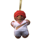 Baseball player gingerbread decoration. Dressed in white outfit with red hat.