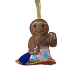 Gingerbread man ornament with a paddle board on a white background