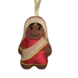 Decorative ornament of a woman in a red sari and gold headscarf on a white background