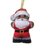 Decorative ornament of a gingerbread man dressed as Santa Claus on a white background