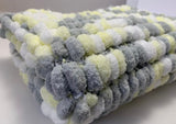 Yellow, grey, white pram blanket.