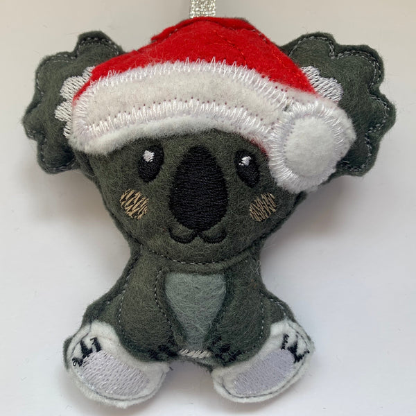 Koala in Santa hat hanging Christmas decoration