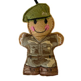 Felt ornament of a soldier in camouflage uniform with a green cap on a white background