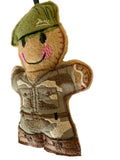 gingerbread man figure of a soldier with a camouflage outfit and green helmet on a white background