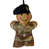 Gingerbread decoration of a REME soldier in military uniform with a navy beret on a white background