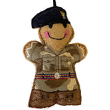 Felt ornament of a person in military uniform with a navy beret on a white background