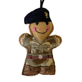 Felt ornament of a person in military uniform with a beret on a white background