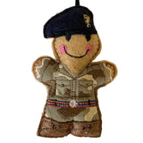 Felt ornament of a person in military uniform with a cap on a white background