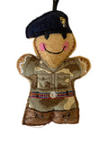 Felt ornament of a person in military uniform with a beret on a white background