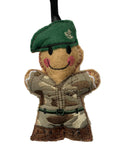 A small embroidered felt soldier ornament with a green beret, camouflage uniform, and black hanging ribbon, shown against a plain light background.