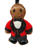 Felt gingerbread man ornament with a red jacket on a white background