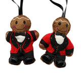 Two gingerbread man ornaments dressed in formal attire on a white background