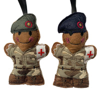 Army medic soldiers in grey and navy berets, gingerbread man decoration.