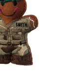 Embroidered patch of a person in military uniform with 'SMITH' embroidered on the sleeve, on a white background.