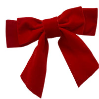 A large red velvet hair bow clip displayed on a white background.