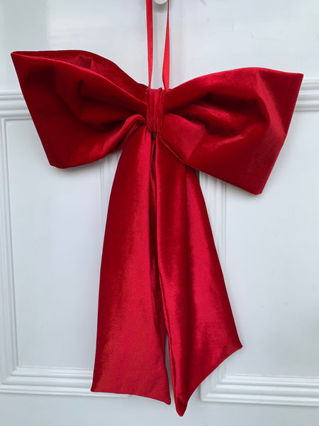 Red bow on a white door