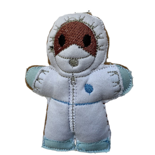 CSI gingerbread man decoration. In white suit with blue gloves and sho covers.
