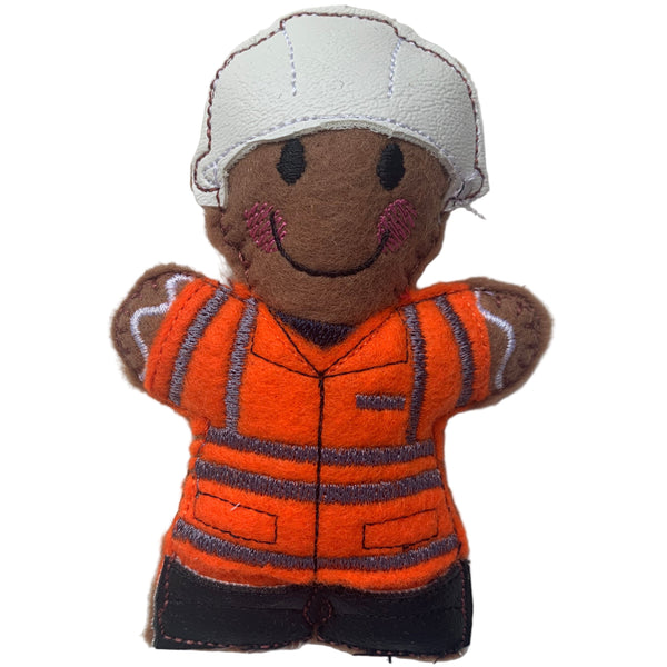 A hand-made felt gingerbread man rail worker in orange jacket, black boots and white hat. designed as a Christmas decoration.