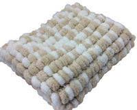 Pom pom blanket knitted.