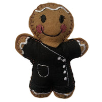 Beautician felt gingerbread decoration. Dressed in black cotton tunic and trousers with white buttons and decorative finish. Lightly filled with a polyester filling to create depth and character. Hand sewn to finish.