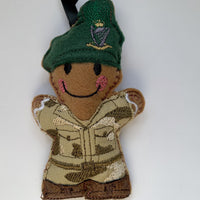 Soldier felt gingerbread decoration. Wearing an embroidered camouflage fabric uniform with brown faux leather boots and green beret with hackle. Lightly filled with a polyester stuffing to create depth and character.