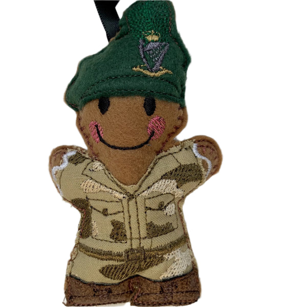 Irish ranger soldier felt gingerbread decoration. Wearing an embroidered camouflage fabric uniform with brown faux leather boots and green beret with hackle. Lightly filled with a polyester stuffing to create depth and character.