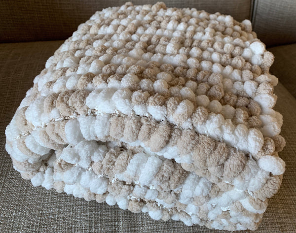 Large beige and white  baby blanket hand knittedin a super soft pom pom wool.