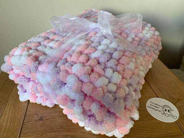 Large hand knitted pink, purple and white hand knitted Pom Pom baby blanket.