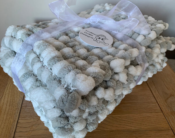 Large silver grey and white hand knitted pom pom baby blanket 
